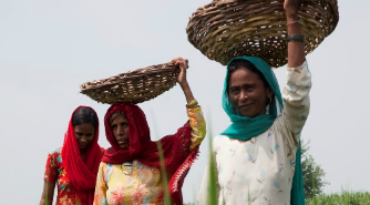 Women in shawls carrying baskets on their heads